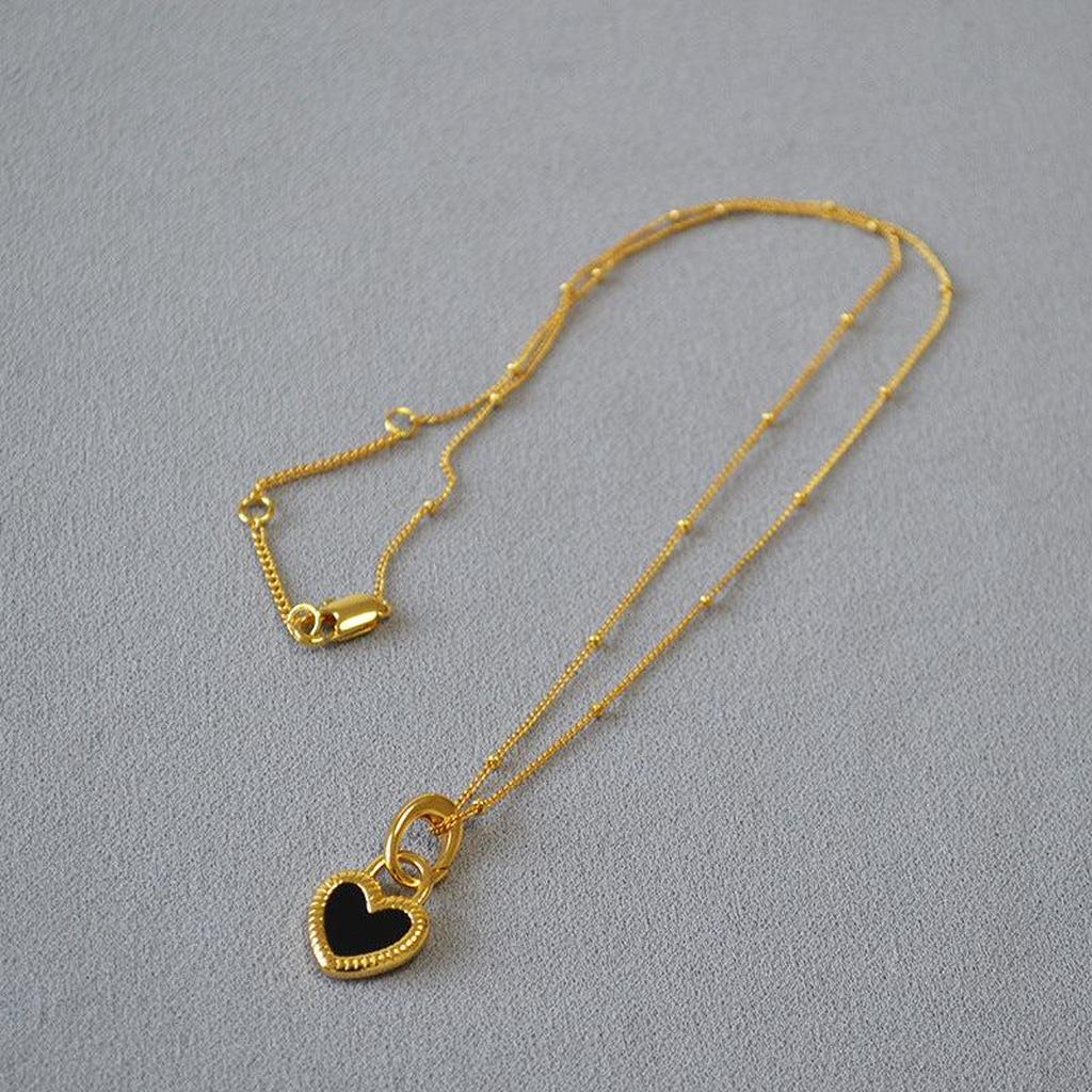Halskette mit schwarz-weissem Herzanhänger in Gold