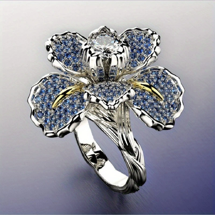 Weissgoldring mit blauen Blüten und Kristall